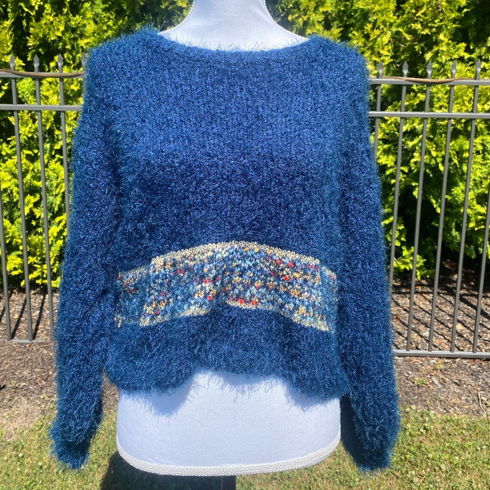 Fuzzy blue sweater with multi-color waist detail